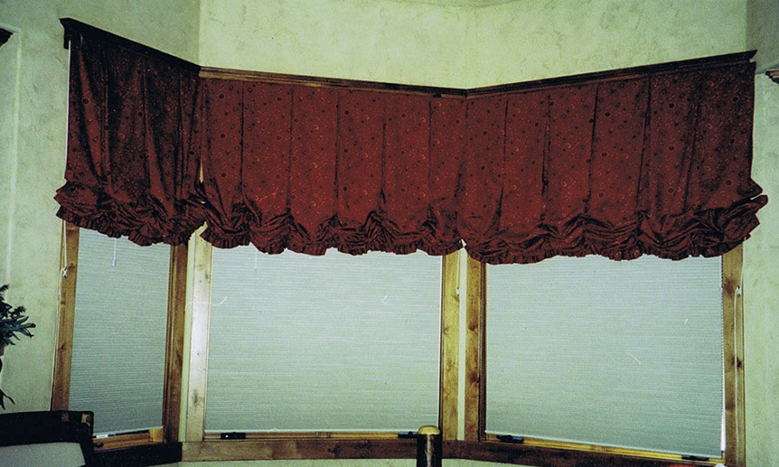 Soft valances  and cornice boards, red shades and wood